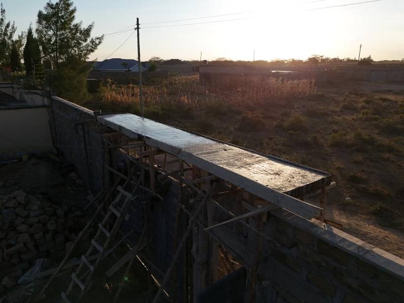 Completed stone perimeter wall at sunset