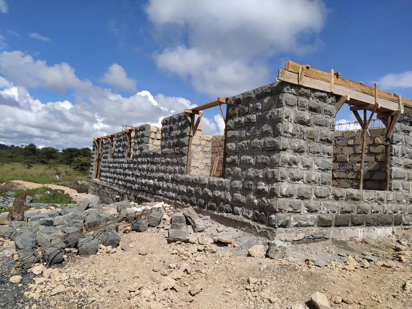 Completed walling with timber roof structure erected
