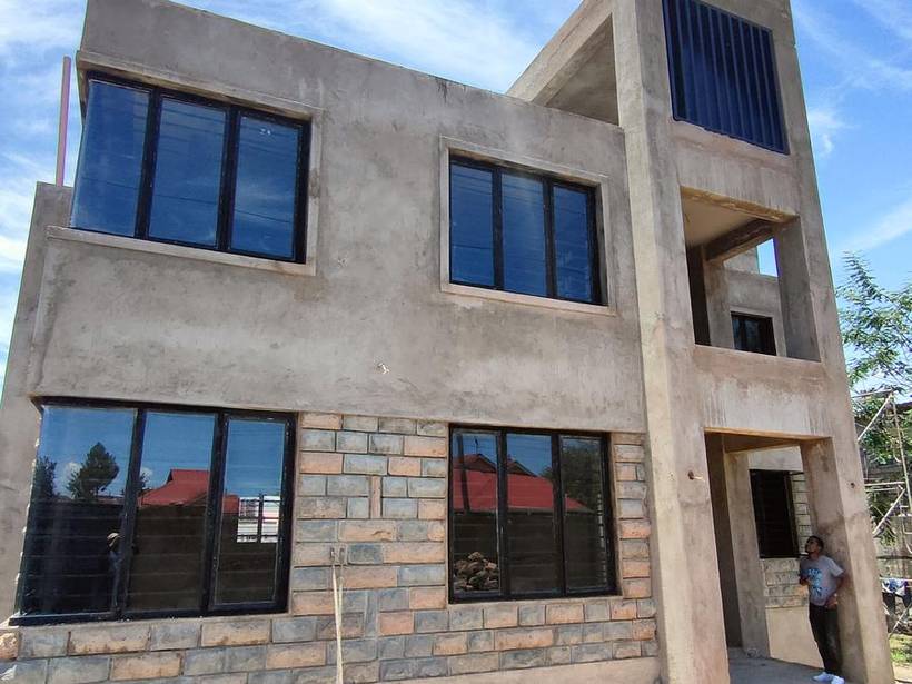 Two-storey maisonette exterior with dressed stone and plaster