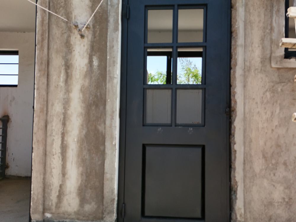 Fabricated steel door fitted into a concrete opening
